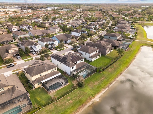 birds eye view of property with a water view and a residential view