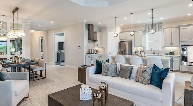 living area featuring baseboards, ornamental molding, and recessed lighting