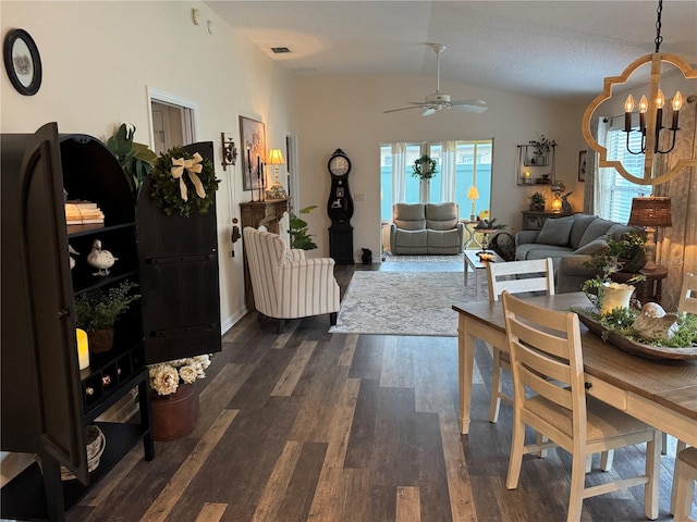 interior space featuring lofted ceiling, visible vents, dark wood finished floors, and ceiling fan with notable chandelier