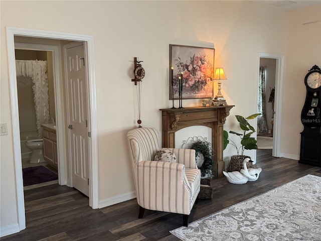 sitting room featuring dark wood finished floors and baseboards