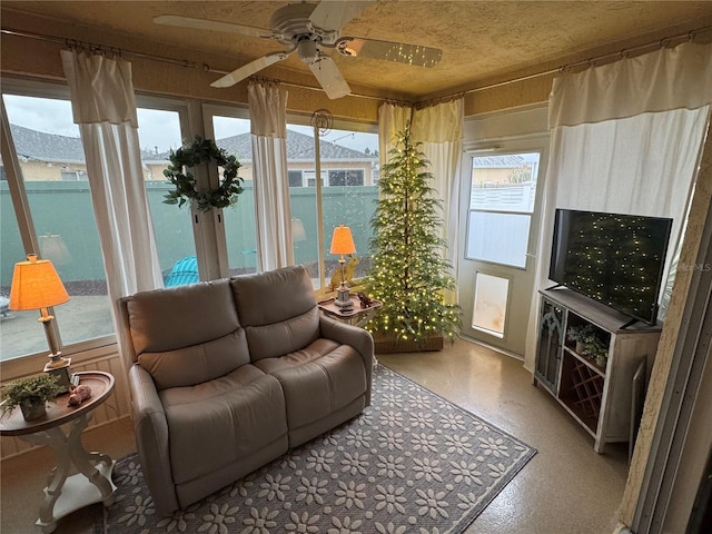 sunroom / solarium with a ceiling fan