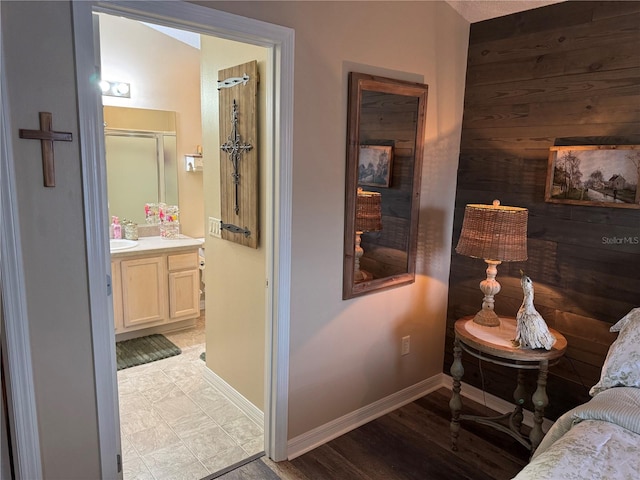 bedroom with ensuite bath and baseboards