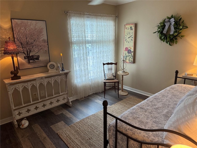 bedroom featuring dark wood-style floors and baseboards