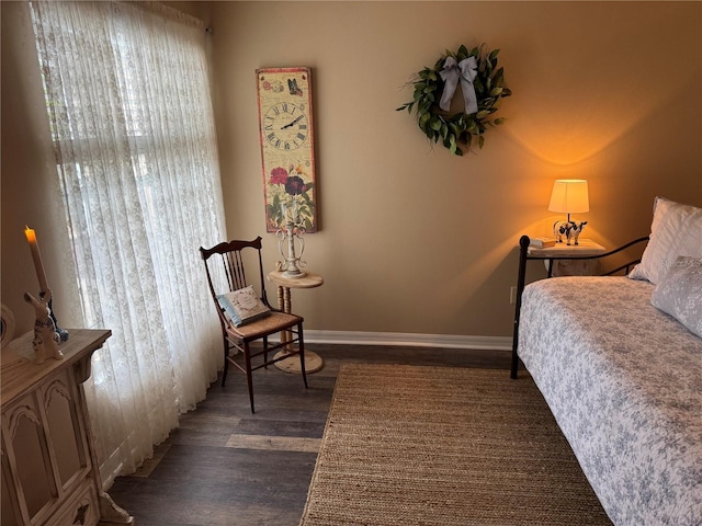 bedroom with dark wood-style flooring and baseboards