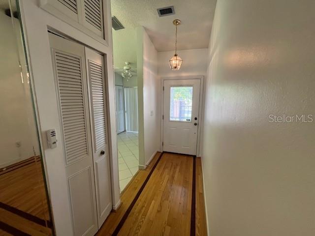 doorway with visible vents and light wood finished floors