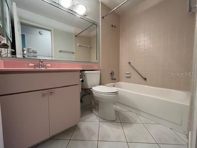 full bath featuring vanity, tile patterned flooring, bathtub / shower combination, and toilet