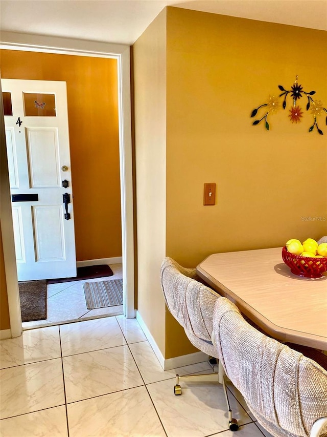 interior space featuring marble finish floor and baseboards