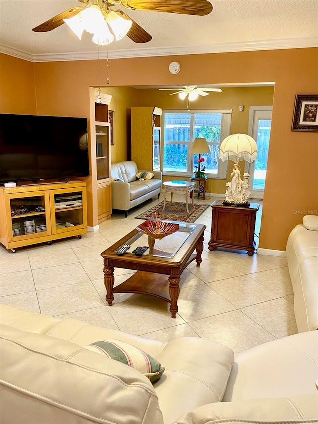 tiled living area featuring ornamental molding, ceiling fan, a textured ceiling, and baseboards