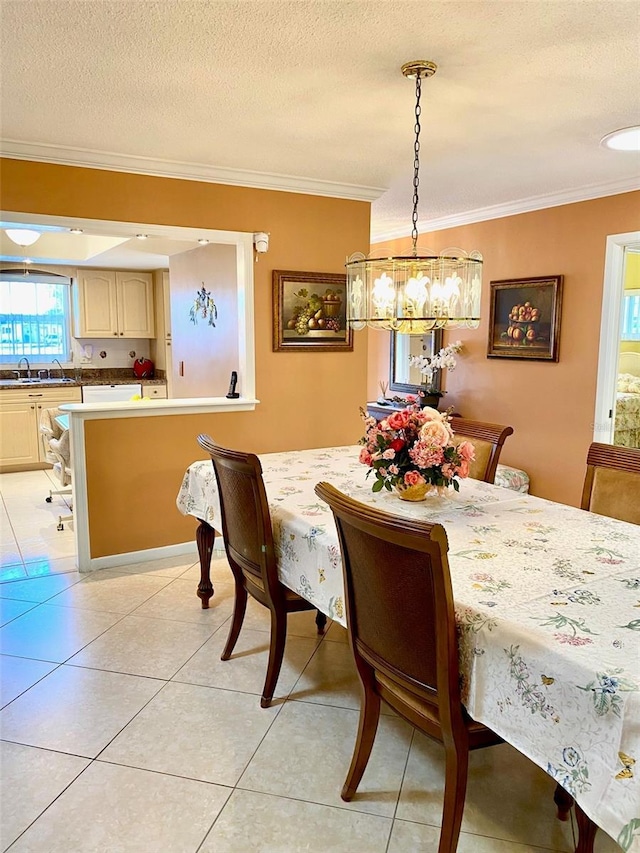 dining area featuring light tile patterned floors, a textured ceiling, and crown molding