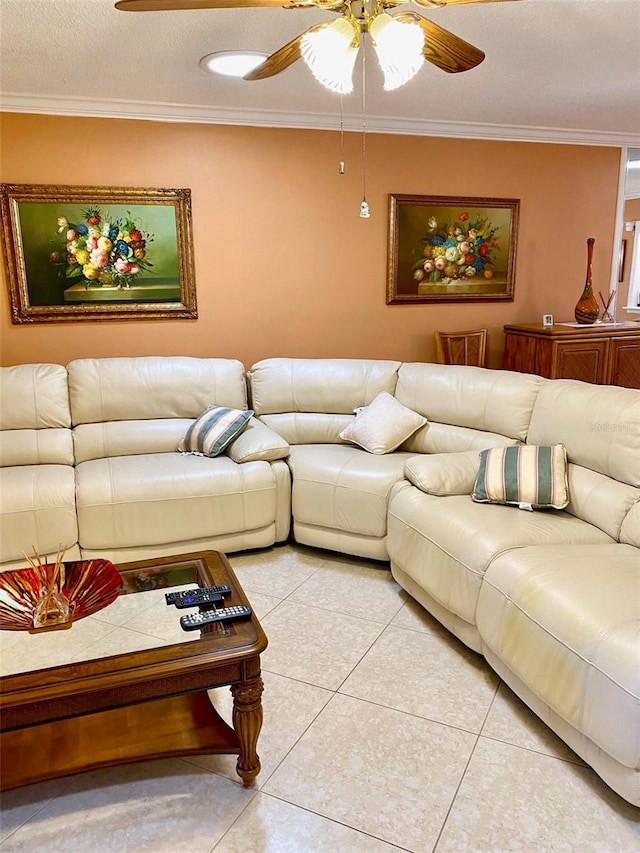 living area with light tile patterned flooring, crown molding, a textured ceiling, and ceiling fan