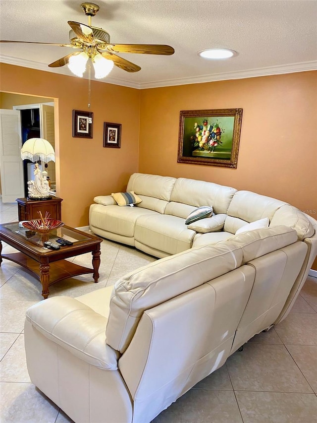 living room with light tile patterned floors, ceiling fan, a textured ceiling, and crown molding