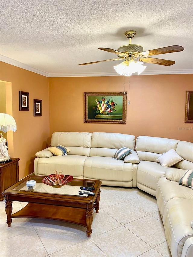 living room featuring ceiling fan, ornamental molding, a textured ceiling, and light tile patterned flooring