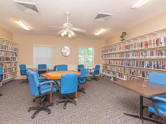 office with carpet, wall of books, and visible vents