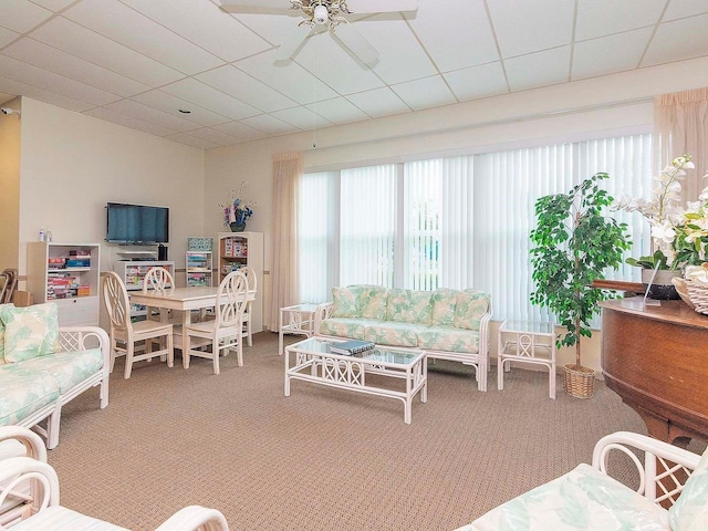 carpeted living room featuring a paneled ceiling and ceiling fan