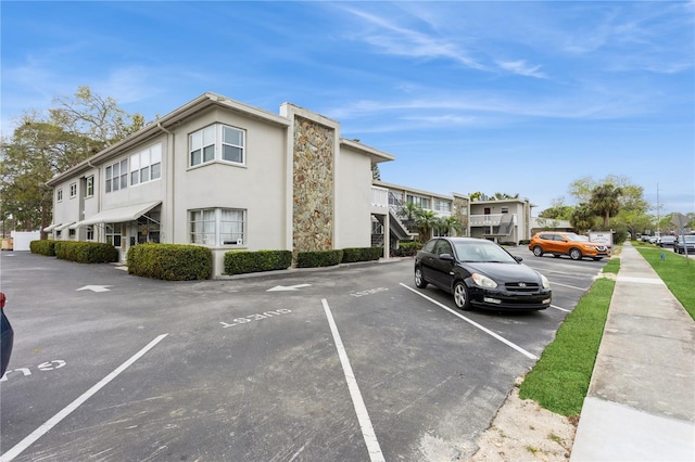 view of property with uncovered parking