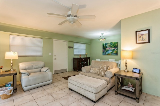 living area featuring ceiling fan and light tile patterned floors