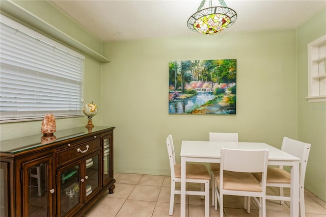 dining room featuring light tile patterned flooring and baseboards