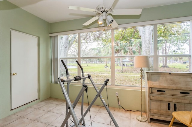 exercise room with light tile patterned flooring