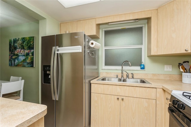 kitchen with a sink, stainless steel fridge with ice dispenser, and light brown cabinetry