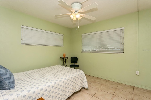 bedroom featuring baseboards, a ceiling fan, and tile patterned floors