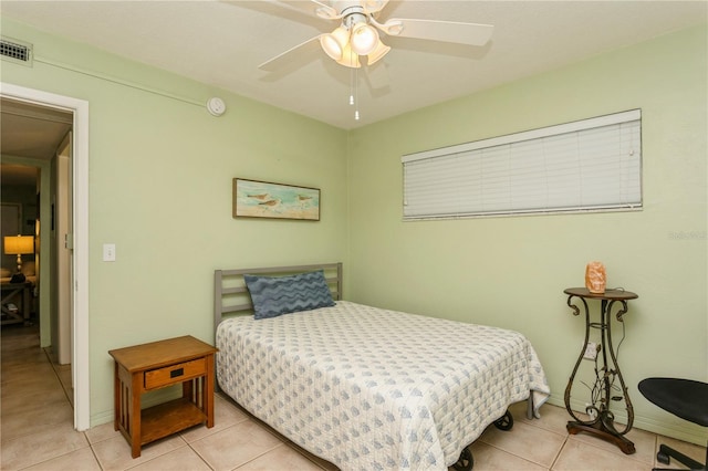 bedroom with baseboards, visible vents, a ceiling fan, and light tile patterned flooring