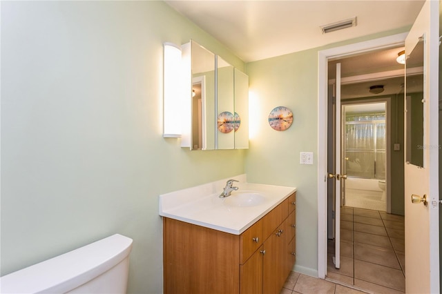 bathroom with visible vents, tile patterned flooring, vanity, and toilet