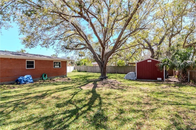 view of yard featuring an outdoor structure, a storage unit, and a fenced backyard