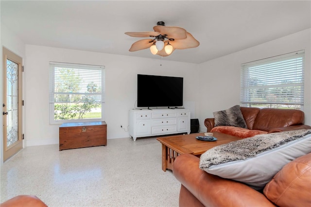 living room with light speckled floor and a ceiling fan