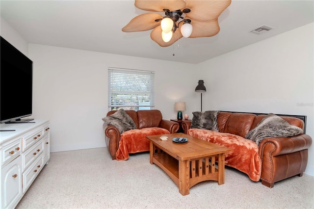 living area with visible vents, baseboards, and ceiling fan