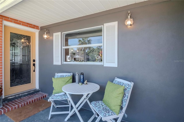 property entrance with brick siding and stucco siding