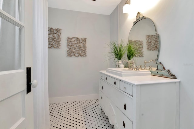 bathroom featuring baseboards and vanity