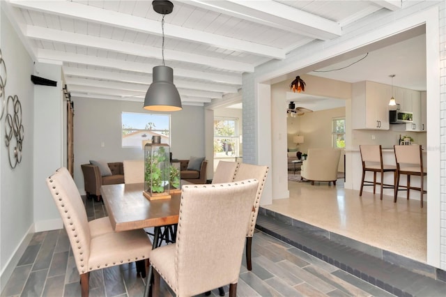 dining area with baseboards, beam ceiling, and wooden ceiling