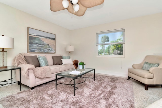 living room featuring baseboards and a ceiling fan