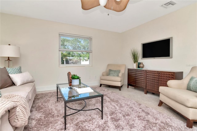 living area with carpet, baseboards, a ceiling fan, and visible vents