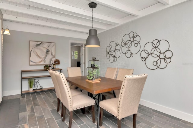 dining space with baseboards, beamed ceiling, wood tiled floor, and wooden ceiling