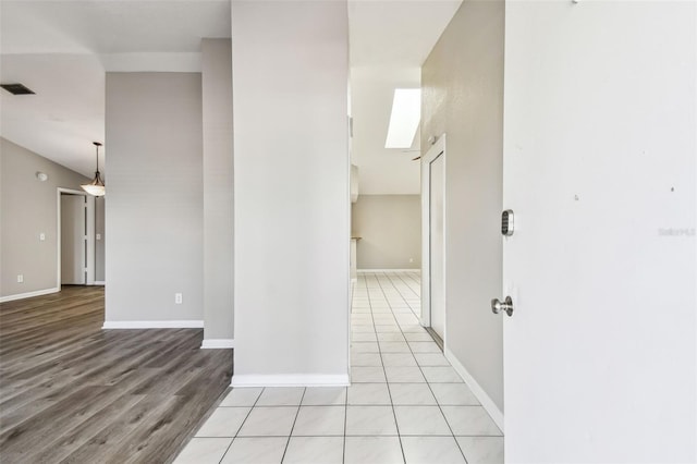 interior space with light wood-style floors, visible vents, and baseboards