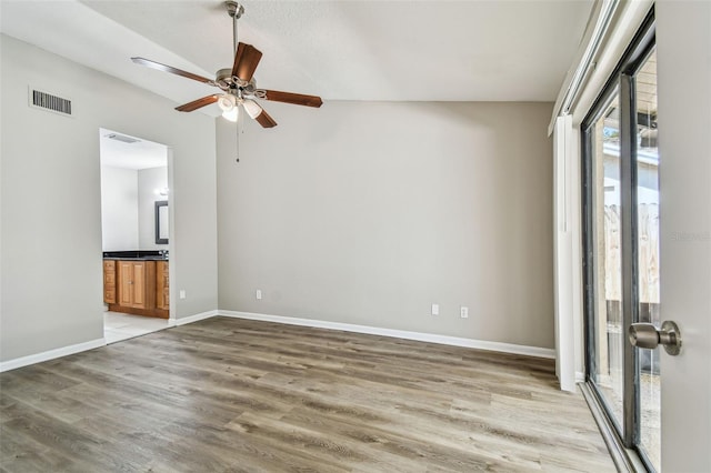 unfurnished room featuring a ceiling fan, light wood-type flooring, visible vents, and baseboards