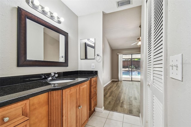 bathroom with a ceiling fan, visible vents, vanity, and tile patterned floors