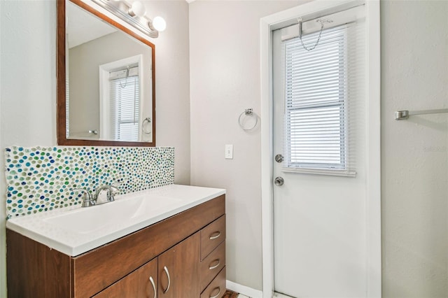 bathroom with tasteful backsplash and vanity