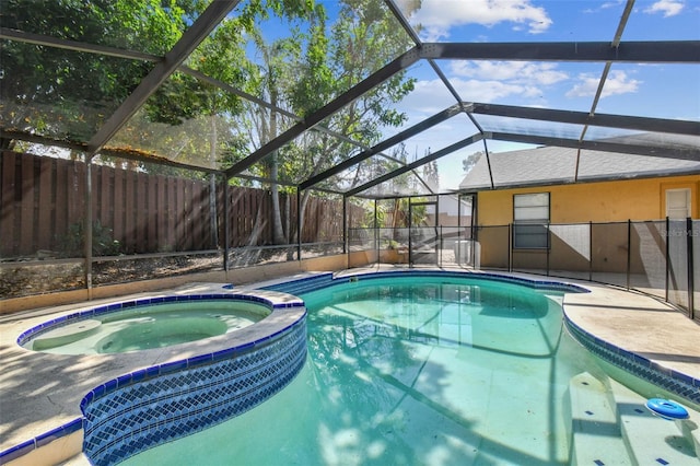 view of pool with glass enclosure, a patio area, a fenced backyard, and a pool with connected hot tub