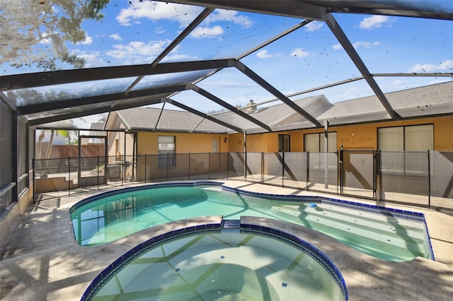 view of swimming pool with a lanai, a pool with connected hot tub, and a patio