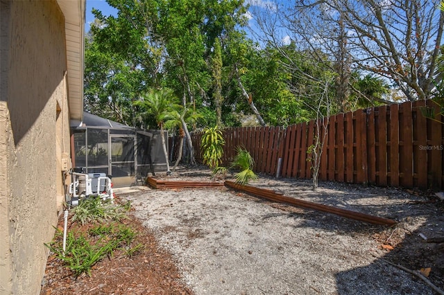 view of yard featuring a lanai and a fenced backyard