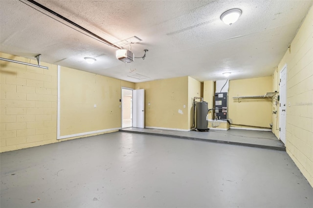 garage featuring a garage door opener, concrete block wall, gas water heater, and heating unit