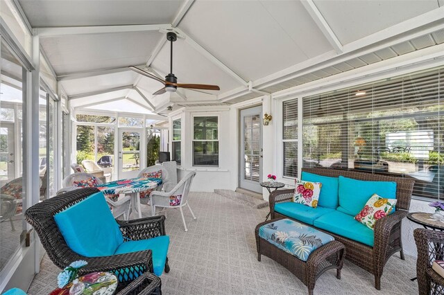 sunroom / solarium with lofted ceiling with beams and a ceiling fan