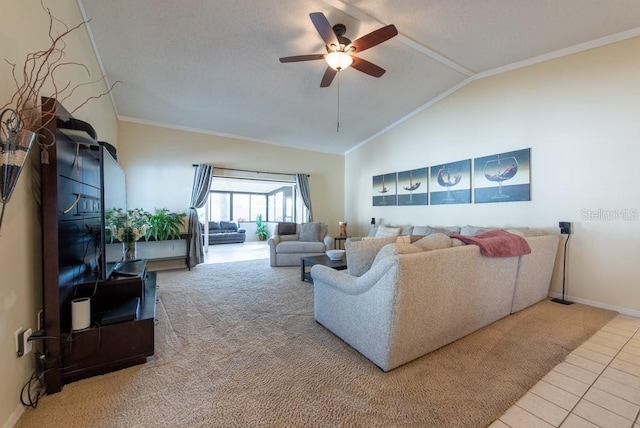 carpeted living room with ornamental molding, vaulted ceiling, ceiling fan, tile patterned flooring, and baseboards