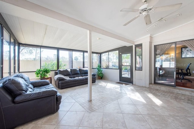 sunroom / solarium featuring vaulted ceiling, ceiling fan, and plenty of natural light