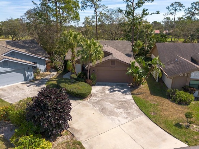 view of front facade with a garage, driveway, and a front lawn