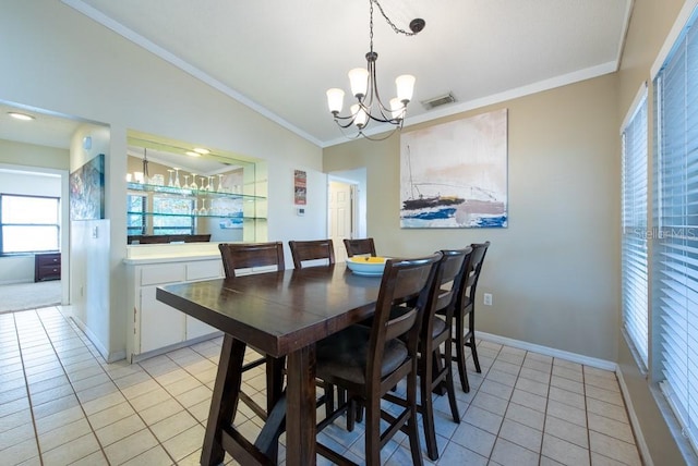 dining room featuring crown molding, light tile patterned flooring, visible vents, and a notable chandelier