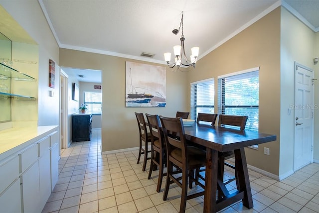 dining space with light tile patterned floors, a chandelier, visible vents, vaulted ceiling, and ornamental molding