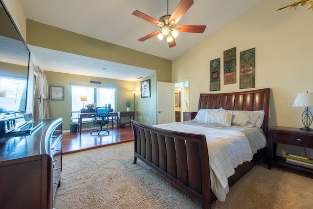 bedroom with vaulted ceiling, ceiling fan, carpet flooring, and baseboards